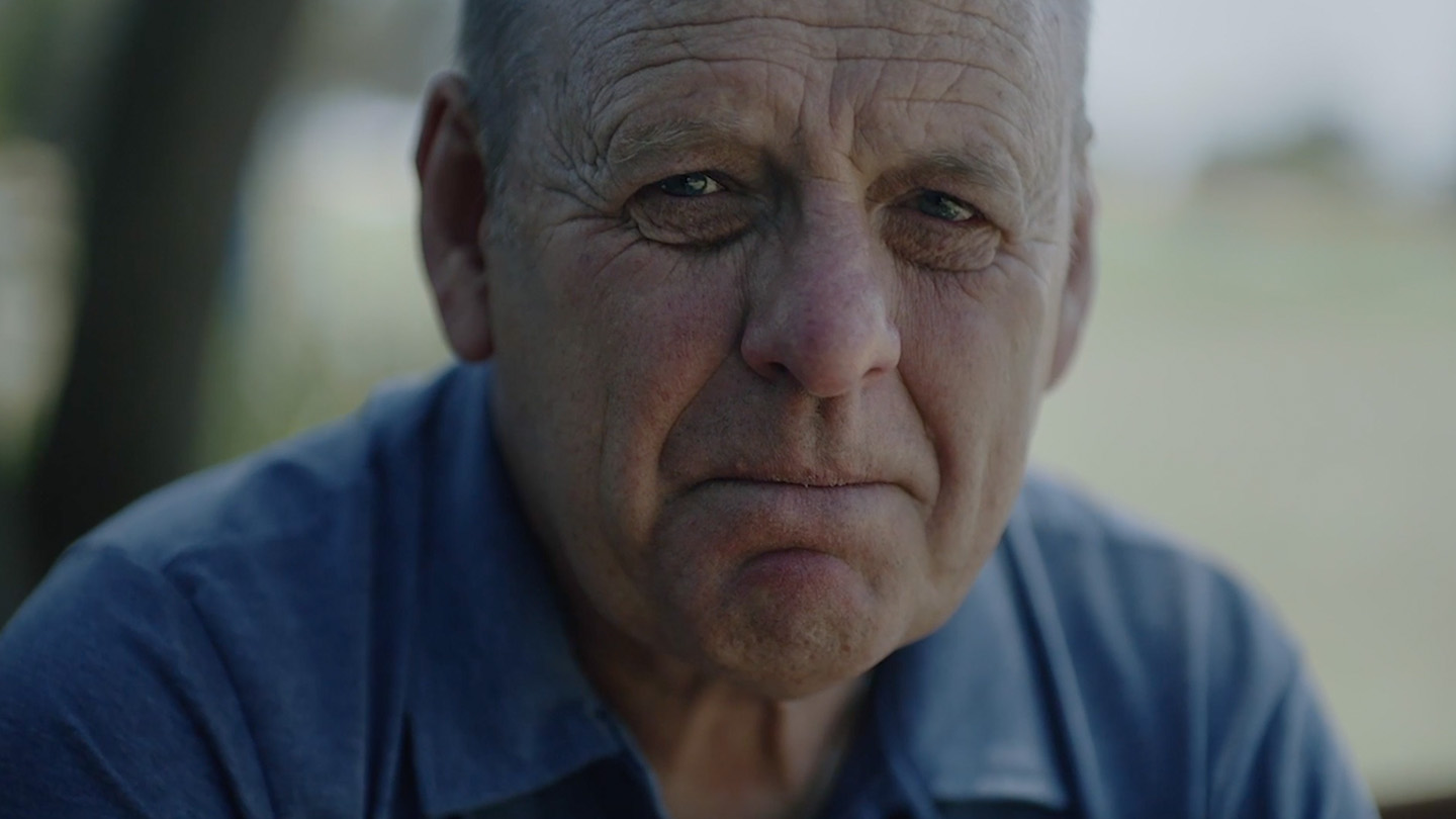 Portrait of an older man with a sorrow expression looking at the camera 